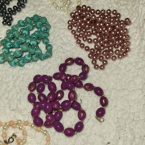 12 random beaded necklaces various colors and sizes.